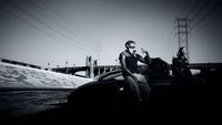 a man sitting on the hood of a car next to a woman