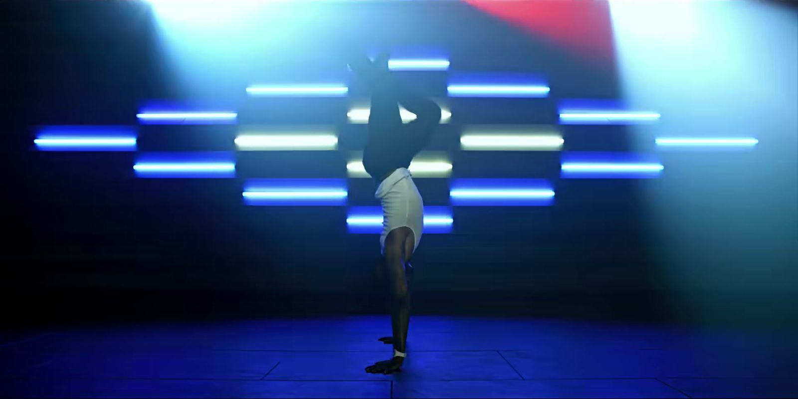 a person doing a handstand on a stage