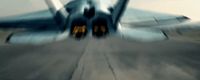 a fighter jet sitting on top of an airport tarmac