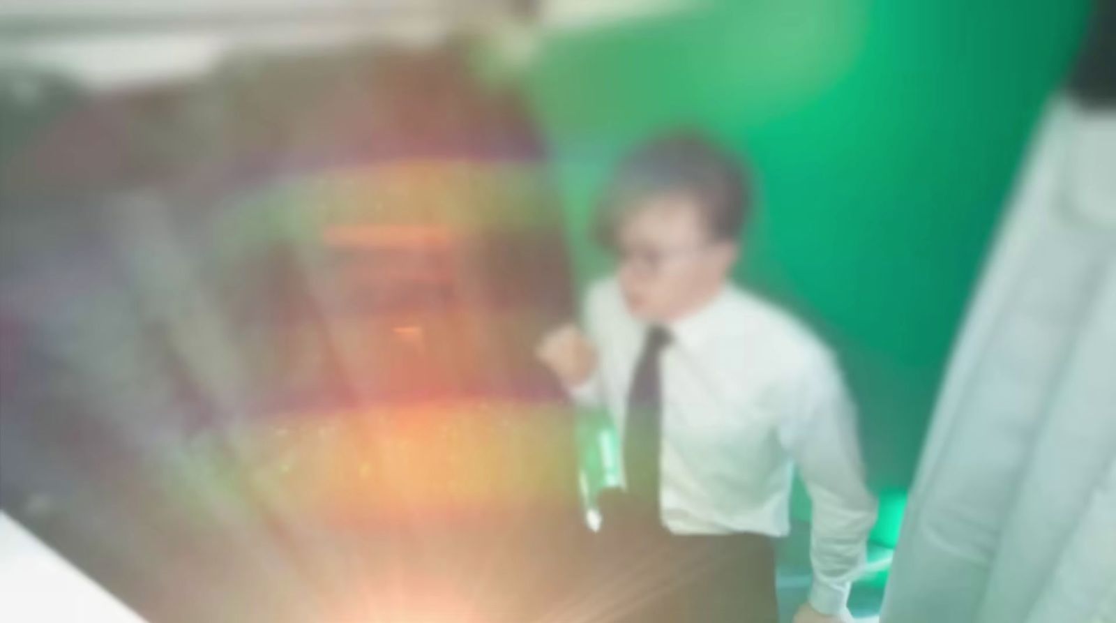 a blurry photo of a man in a tie