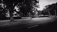 a black and white photo of a man on a skateboard