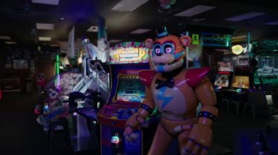 a video game machine with an animated character next to it