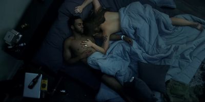 a man and a woman laying in bed together