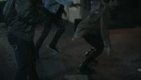 a group of young men riding skateboards down a street