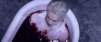 a person in a bathtub with blood on it