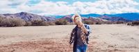 a man standing in the middle of a desert