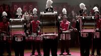 a group of men in uniform playing drums