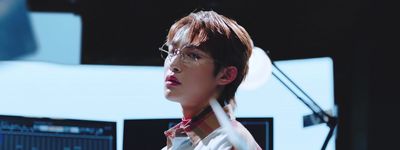 a young man wearing glasses and a red tie