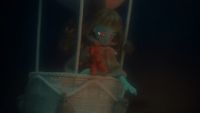 a creepy doll sitting inside of a basket