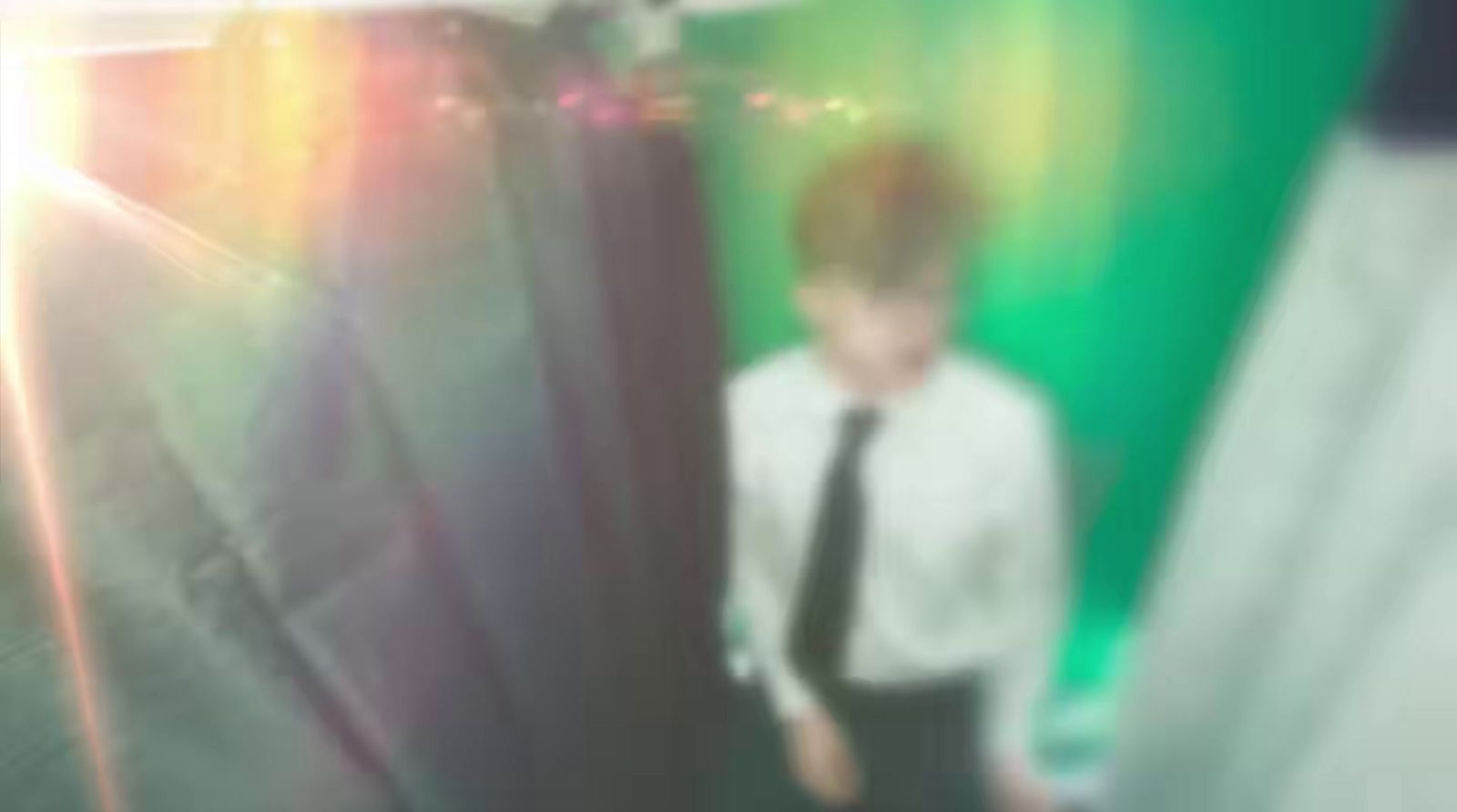 a blurry photo of a man in a tie