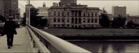 a person walking on a bridge over a river