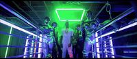 a group of people standing in a room with neon lights