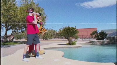 a couple of men standing next to each other near a pool