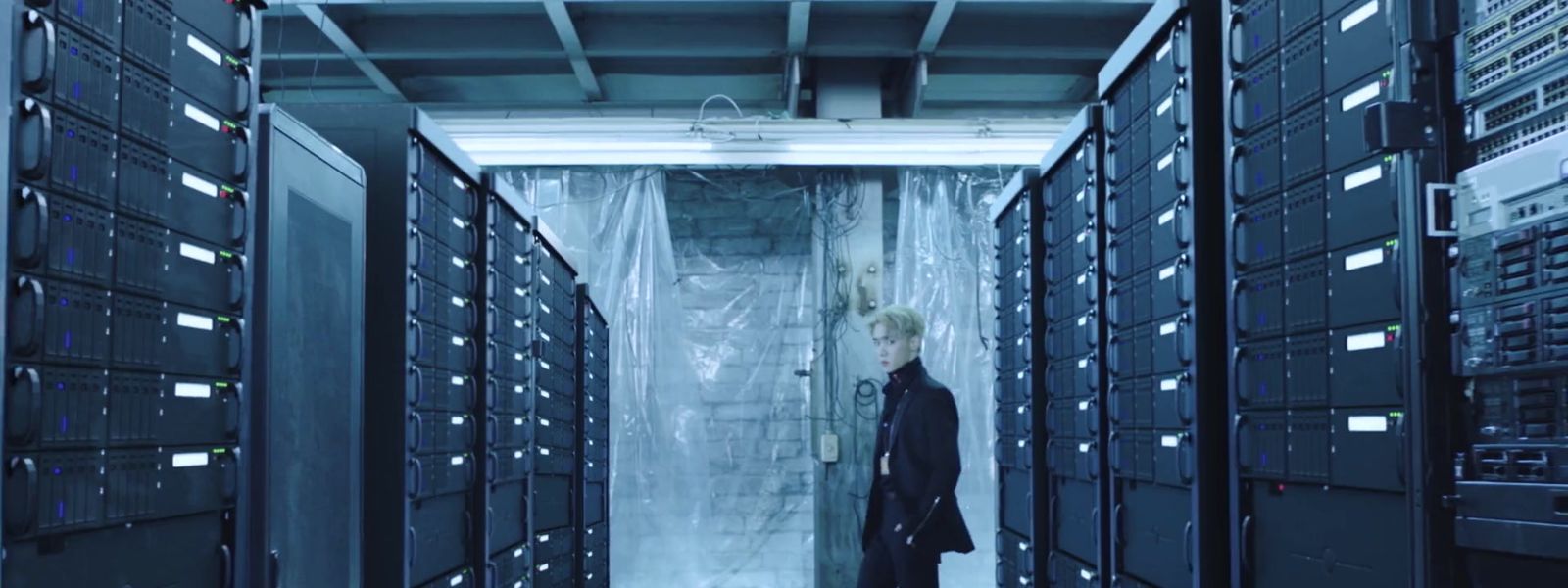 a person standing in a room with lots of servers