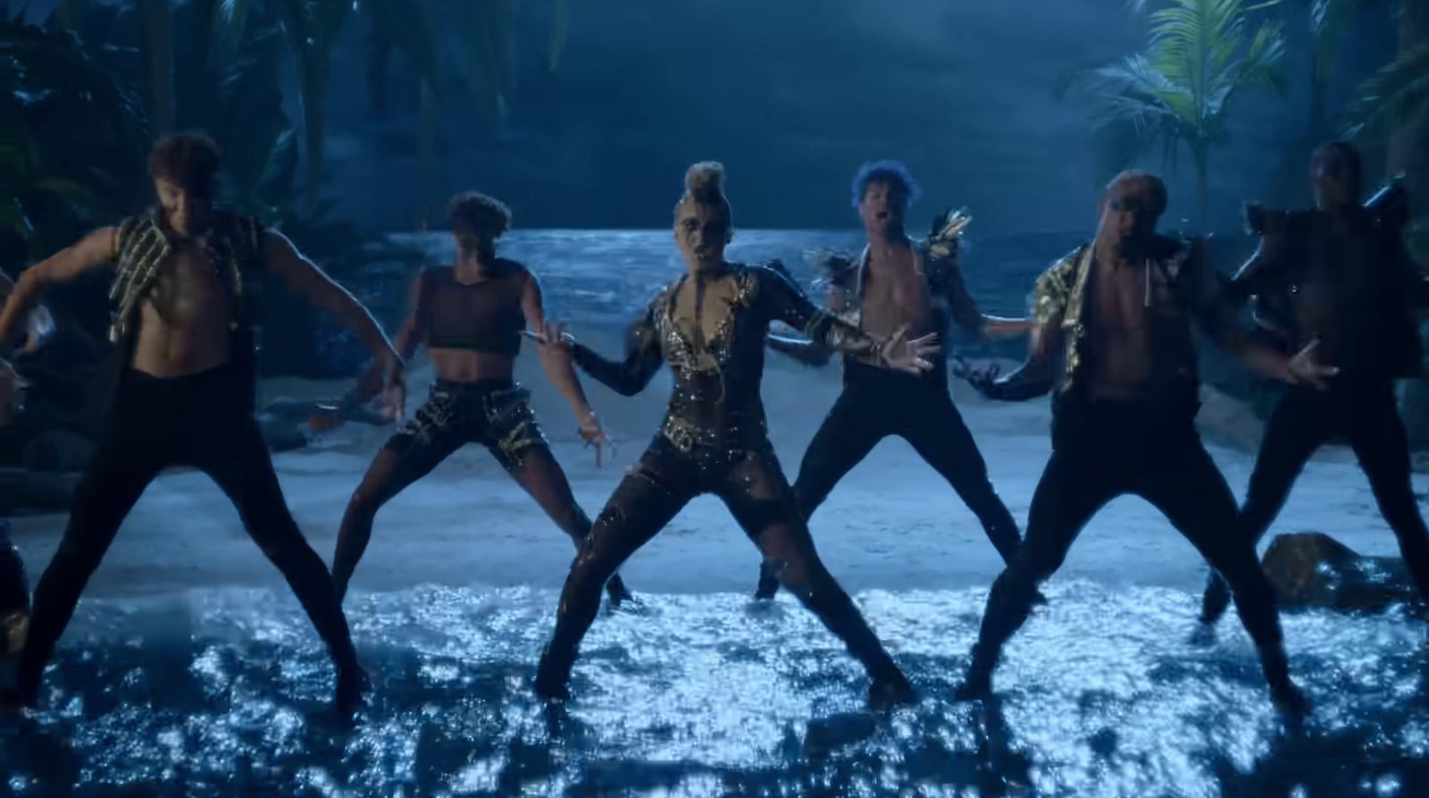 a group of men dancing on top of a body of water