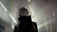 a person standing in a dark room with a book