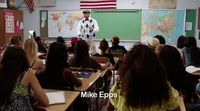 a man standing in front of a classroom full of students