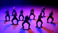 a group of people standing on top of a stage