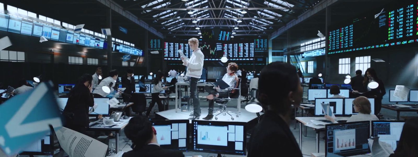 a group of people standing around a room filled with computers