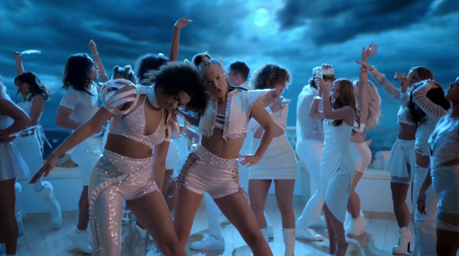 a group of women dressed in white dancing