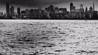 a large body of water with a city in the background