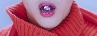 a close up of a woman's mouth with a diamond on it