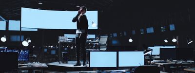 a man standing on top of a stage in front of a crowd