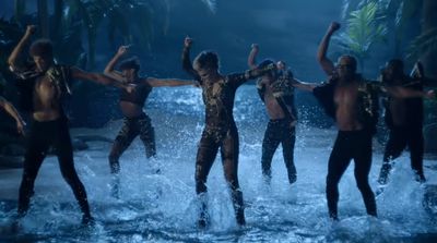 a group of people standing on top of a body of water