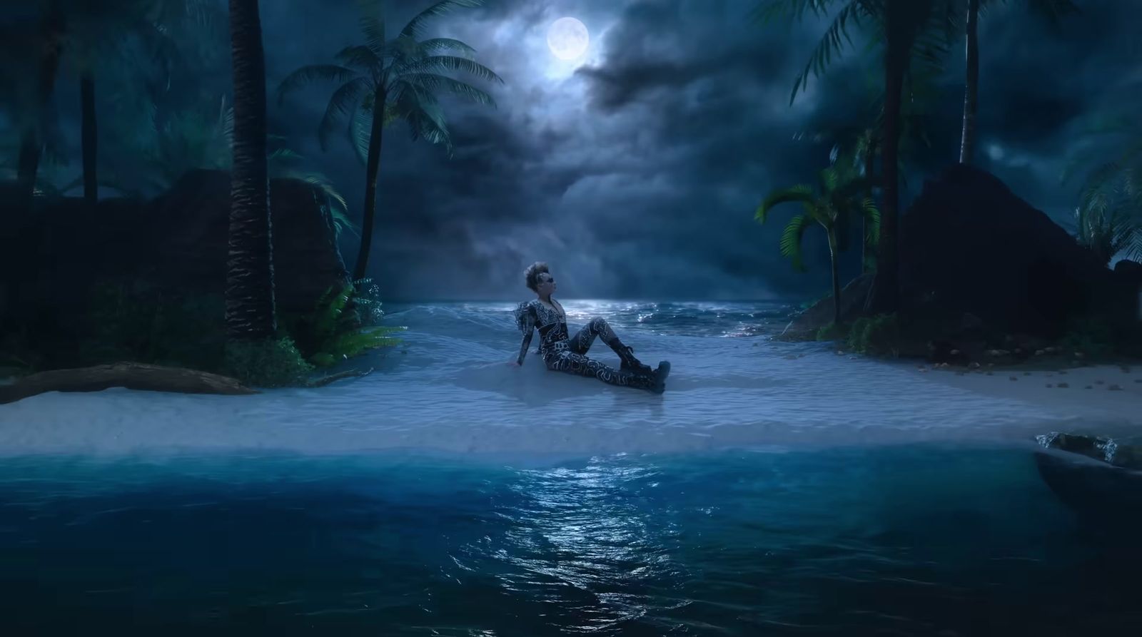 a man sitting in the middle of a body of water