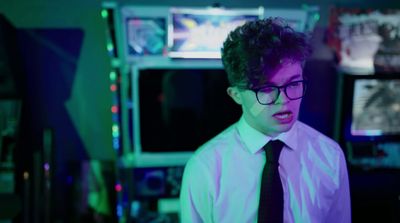 a young man wearing glasses and a tie