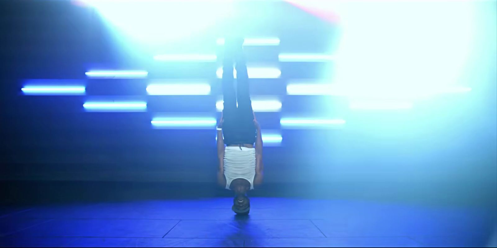 a person doing a handstand on a stage