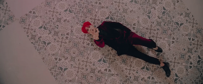 a person laying on a bed with a red hat