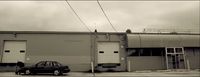 a black car parked in front of a building