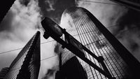 a black and white photo of two tall buildings