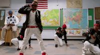 a group of young men dancing in a classroom