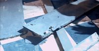 a piece of metal sitting on top of a wooden floor