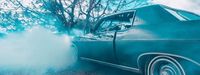 a blue car with smoke coming out of it