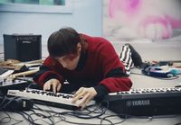 a person sitting at a table with a keyboard