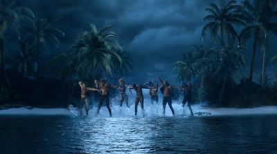 a group of people standing on top of a body of water