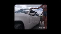 a woman standing next to a white truck