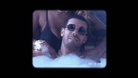 a man wearing sunglasses in a bubble bath