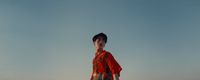 a woman standing on top of a sandy beach