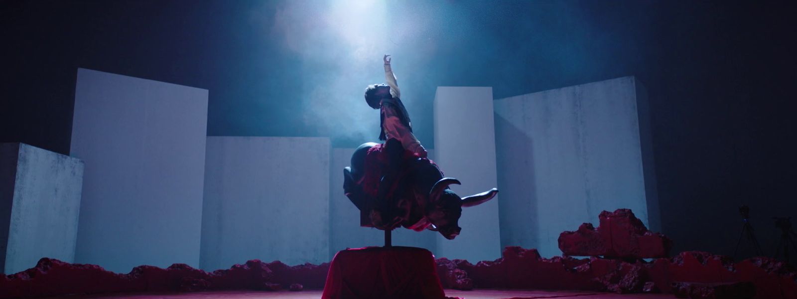 a woman standing on top of a red stool