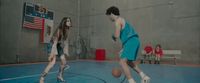 a group of young people playing a game of basketball