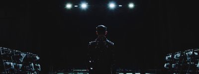 a man standing in front of a black background