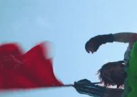 a blurry image of a man holding a red flag