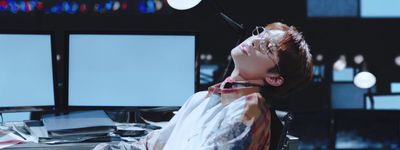 a woman sitting in front of a computer desk