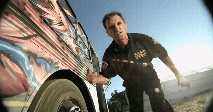 a man in a police uniform standing next to a car