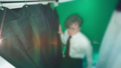 a blurry photo of a young man in a tie