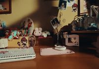 a wooden table topped with a cake covered in frosting